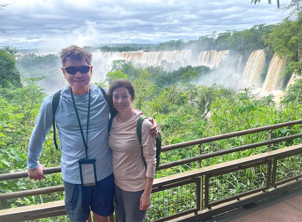 Smiling against the breathtaking power of the Iguazu Falls