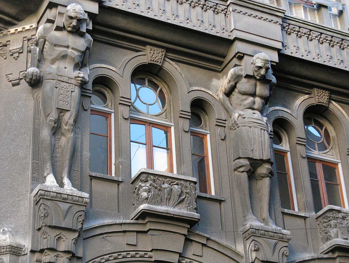 The Wulf building has 8 human figures that appear to be holding the building on their backs