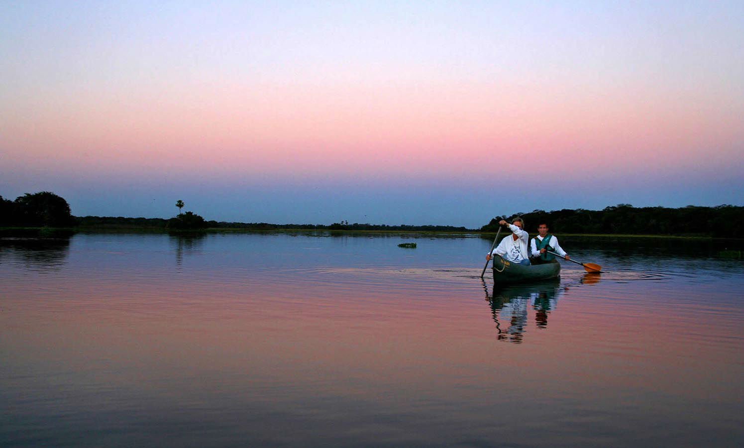 Witness a beautiful sunset while canoeing on the waters of the Pantanal