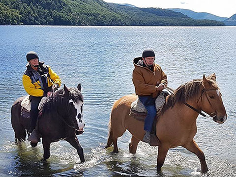 Curtis & Darell horseback riding in the Bariloche Lakes