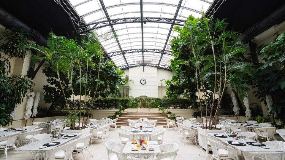 Winter Garden at Loi Suites Recoleta with glass roof and greenery
